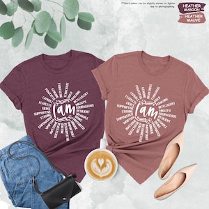 a couple of t - shirts that are next to a cup of coffee