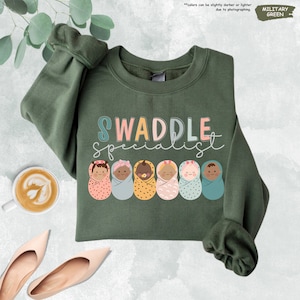a sweater with the words swaddle spelled on it