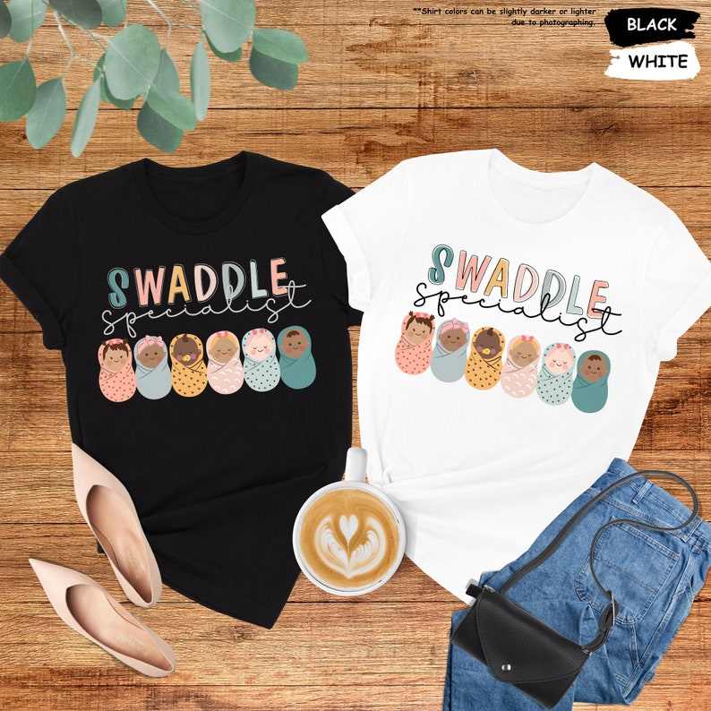 a couple of t - shirts sitting on top of a wooden floor