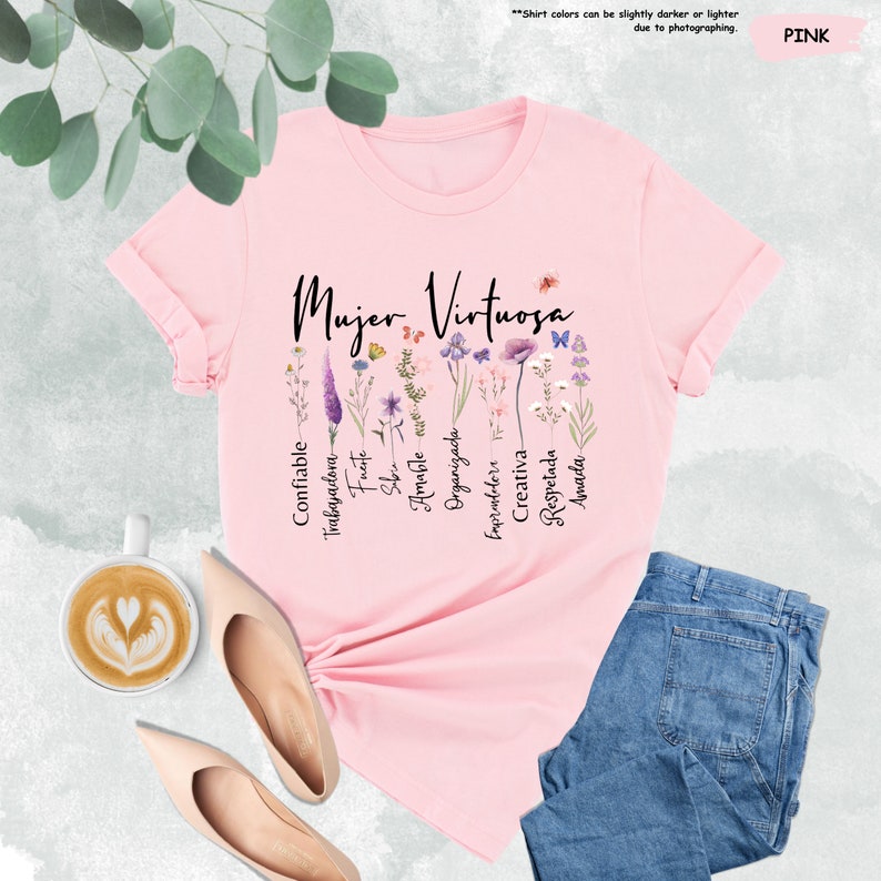 a pink t - shirt with a floral design and a cup of coffee