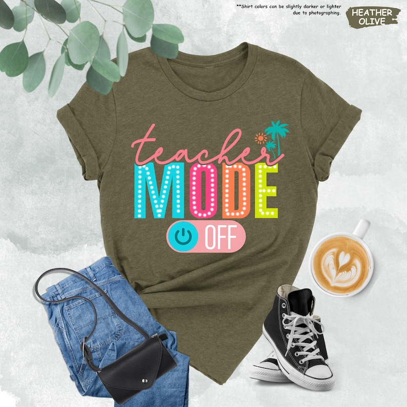 May include: A heather olive t-shirt with the text "teacher MODE OFF" in colorful letters. The text is stylized to look like a light-up sign. A power button graphic is below the text.