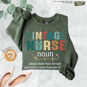 a green shirt with a message that says vintage nurse knows more than she says and