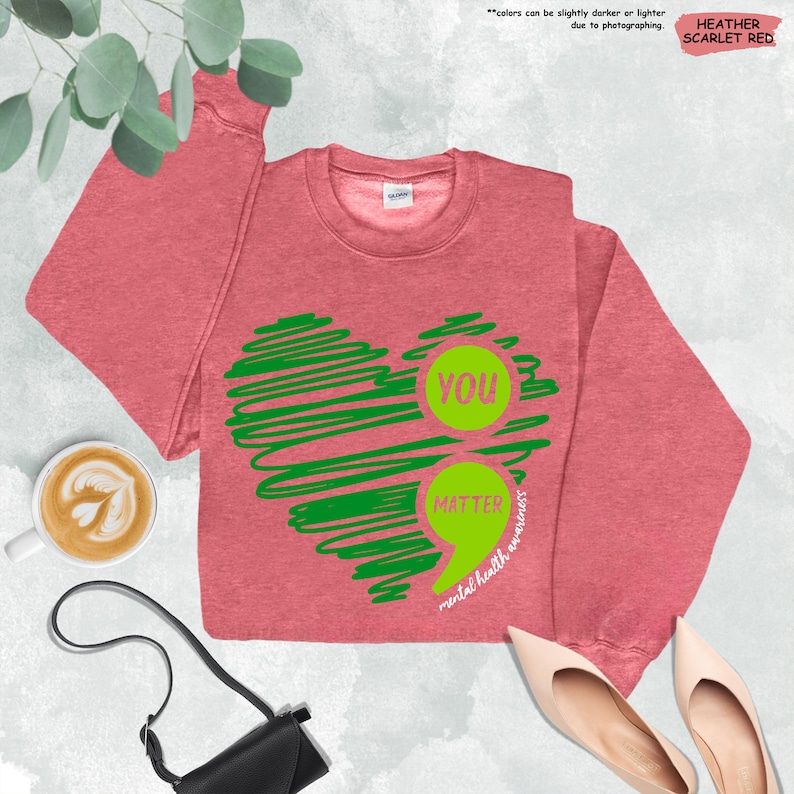 a pink shirt with a green heart on it