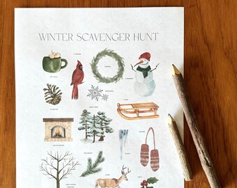 May include: A printed "Winter Scavenger Hunt" sheet with watercolor illustrations of winter-themed items like a snowman, pine branch, and mittens. Two wooden pencils rest on a wooden surface next to the sheet.