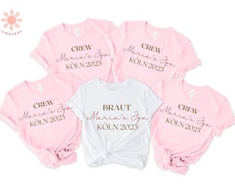 May include: Four pink t-shirts with the text "CREW Maria's Iga KÖLN 2025" and one white t-shirt with the text "BRAUT Maria's Iga KÖLN 2025".