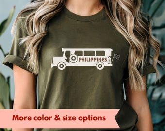 May include: A green t-shirt with a white graphic of a jeepney, a common mode of transportation in the Philippines, with the word "PHILIPPINES" printed on the side. The t-shirt is available in army green.