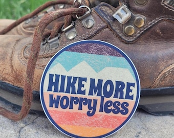 Hike More Worry Less Sticker: Colorful Textured Mountains and Sky