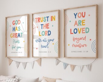 May include: Three framed wall art prints with light wood frames featuring colorful text and small star icons. The prints display the phrases God Has Great Plans For You, Trust In The Lord With All Your Heart, and You Are Loved Beyond Measure.