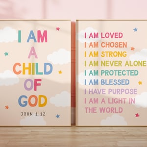 May include: Two framed wall art prints with a light beige background, white clouds, and colourful stars. The left print reads I AM A CHILD OF GOD JOHN 1:12. The right print lists affirmations including I AM LOVED, I AM CHOSEN, and I AM STRONG.