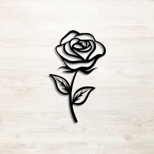 May include: Black metal rose wall art. The rose features detailed petals, leaves, and stem. The design is a silhouette, perfect for adding a touch of nature-inspired decor to any space. The rose is approximately 12 inches tall.