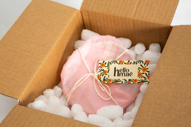 Packaged mini plate/saucer with pink tissue paper and hellomaë swing tag.