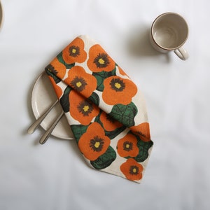 42 cm x 42 cm square napkin with large wonky nasturtium design print on off white base colour, 94%cotton/6% linen textured fabric.