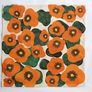 42 cm x 42 cm square napkin with large wonky nasturtium design print on off white base colour, 94%cotton/6% linen textured fabric.