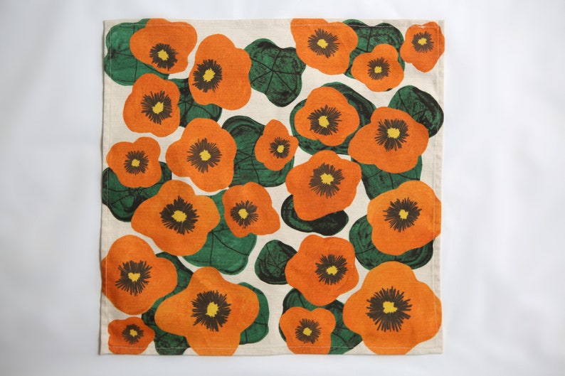 42 cm x 42 cm square napkin with large wonky nasturtium design print on off white base colour, 94%cotton/6% linen textured fabric.