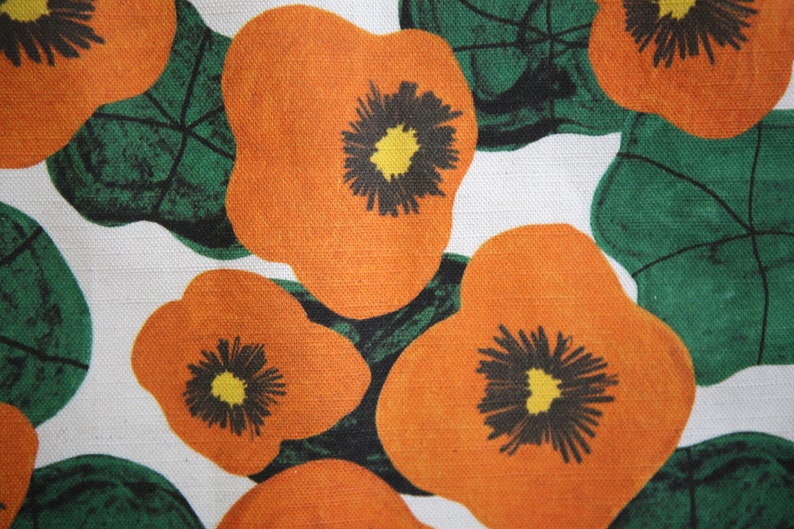 Close up napkin with large wonky nasturtium design print on off white base colour, 94%cotton/6% linen textured fabric.