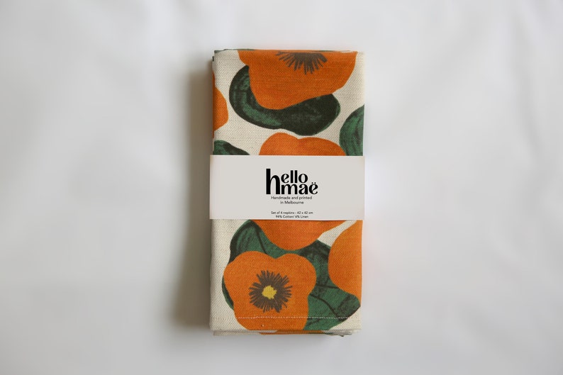 packaged set 4 - 42 cm x 42 cm square napkin with large nasturtium design print on off white base colour, 94%cotton/6% linen textured fabric.