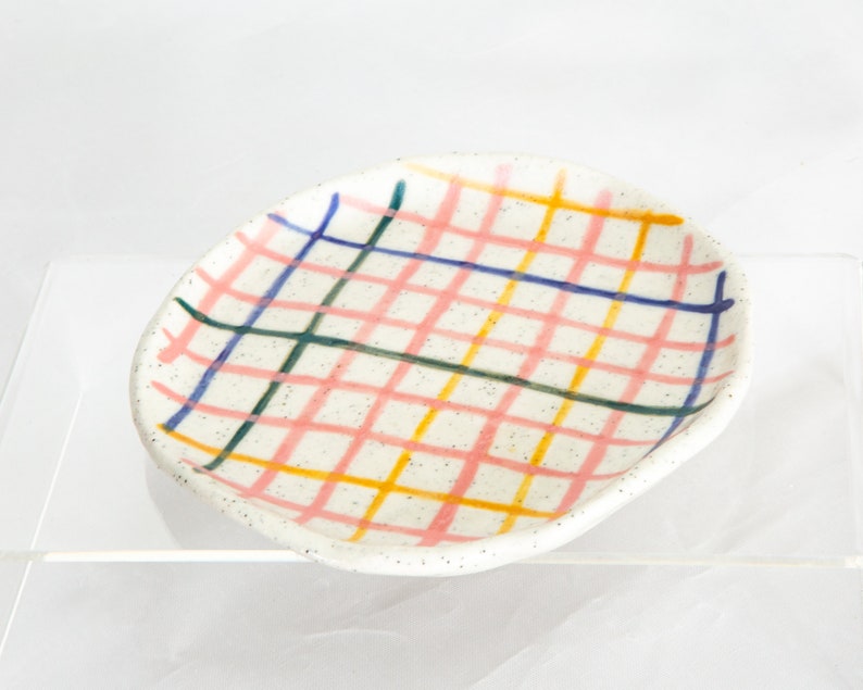 13.5cm ceramic mini plate with check design. Colours are yellow, pink,blue and green on white speckled clay.