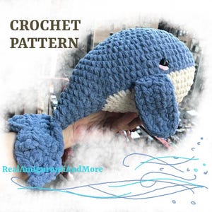 May include: Crochet pattern for a blue whale amigurumi toy. The whale is made with a textured stitch and has a white belly. The pattern is available for purchase.