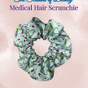 May include: Medical hair scrunchie in medical blue, patterned with medical symbols like stethoscopes, pills, and bandages. The scrunchie is from "The Seasons of Beauty" collection.
