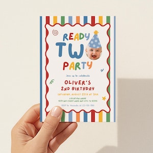 May include: A rectangular birthday invitation card featuring a colorful vertical striped border and a scalloped red frame. The text reads READY TWO PARTY, Oliver's 2nd Birthday, with date, time, location, and RSVP details. Includes a photo of a child.