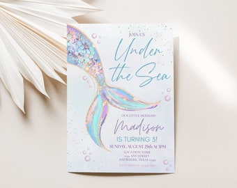 May include: A light blue and purple mermaid tail with gold glitter accents on a white background. The text "Join Us Under the Sea" is written in blue script. The text "Our Little Mermaid Madison is Turning 3!" is written in black. The text "Sunday, August 25th at 3PM" is written in black. The text "Location Name Any Street Anywhere, Texas" is written in black.