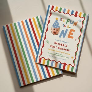 May include: Two colorful birthday invitations. One features a photo of a baby wearing a party hat and the text "It's FUN to be ONE." The other has a striped pattern in red, blue, green, orange, and yellow.