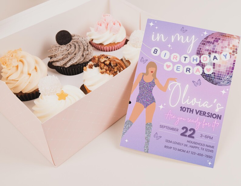 May include: A box of cupcakes with various toppings, including frosting, nuts, and an Oreo cookie. Next to the box is a lavender birthday invitation with a disco ball illustration and the text "Olivia's 10th Version."