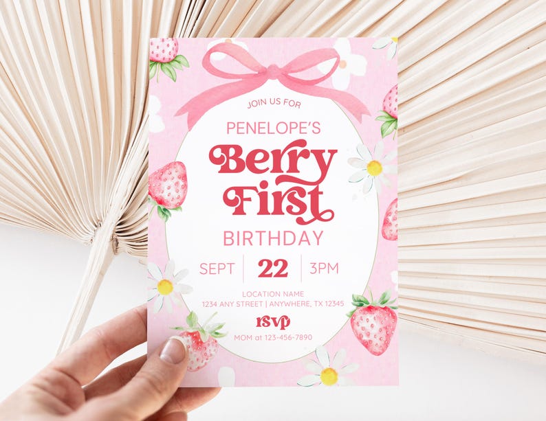 Berry First Birthday invitation featuring a sweet strawberry theme with a soft pink background, playful retro-style red lettering, and daisy accents. The design includes a pink bow at the top, fresh strawberries around the edges, and white floral details for a cheerful boho vibe. Perfect for celebrating a little girl’s first birthday with a fun and trendy berry-inspired party theme.