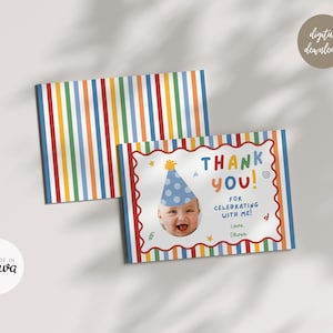 May include: A rectangular thank you card featuring a colorful vertical striped pattern in red, orange, yellow, green, and blue. The card displays a photo of a smiling baby wearing a blue polka dot party hat, with the text THANK YOU! FOR CELEBRATING WITH ME! Love, Oliver.