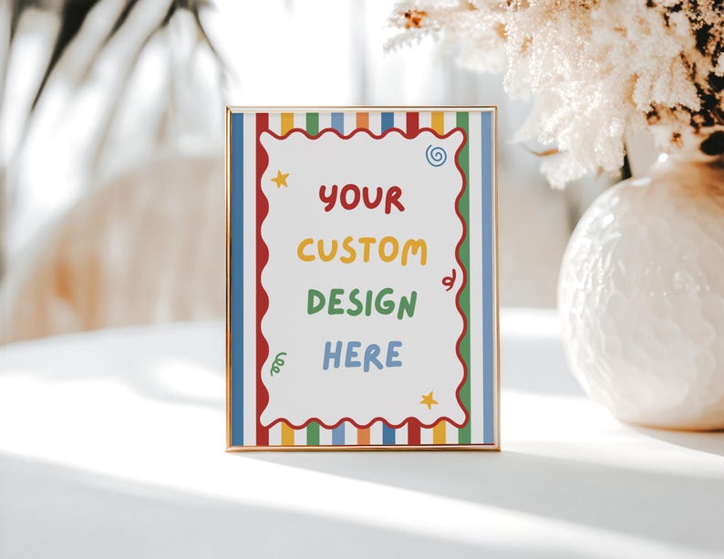 May include: A rectangular gold-toned frame containing a white sign with a scalloped red border. The sign features vertical stripes in red, blue, green, and yellow, with the text "YOUR CUSTOM DESIGN HERE" in colorful letters and small star and swirl icons.