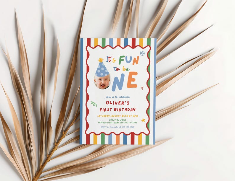 May include: A colorful birthday invitation with the text "It's FUN to be ONE." The invitation features a photo of a baby wearing a party hat and is decorated with a striped border in various colors. The invitation is for Oliver's first birthday.