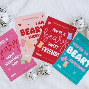 May include: Four Valentine's Day cards with bear-themed puns and colorful gummy bear illustrations. The cards are pink, red, and teal, with phrases like "Have a beary Happy Valentine's Day!" and "You're so beary awesome!" Disco balls are in the background.