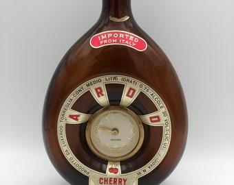 Vintage 1970s advertising brown glass bottle of Italian ARDO Cherry Liquor with German Mercedes mechanical clock