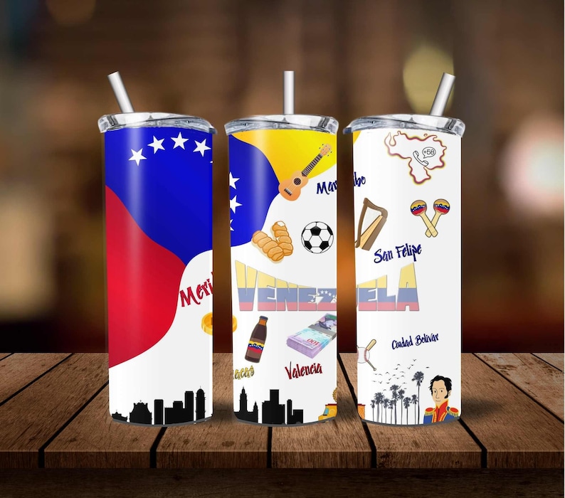 May include: Three stainless steel tumblers with lids and straws. Each tumbler features a different design inspired by Venezuela. The first tumbler has the Venezuelan flag, the second has a soccer ball, a guitar, and the word "Venezuela", and the third has a map of Venezuela with the words "San Felipe" and "Ciudad Bolivar".