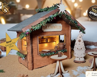 May include: A laser-cut wooden miniature stall with a sign reading GLÜHWEIN, decorated with faux greenery and a star. Includes a gnome figure and two small round tables. Text indicates a design for 4 mm and 3 mm thickness, with file formats AI, DXF, SVG, LBRN2, and PDF.