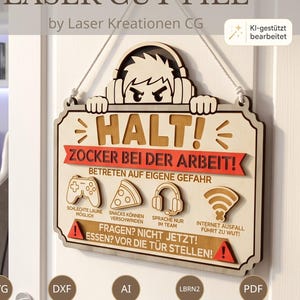 May include: A laser-cut wooden sign featuring a cartoon character wearing headphones peering over the top. The sign reads HALT! ZOCKER BEI DER ARBEIT! with icons for a controller, pizza, headset, and Wi-Fi, plus additional German text warnings.