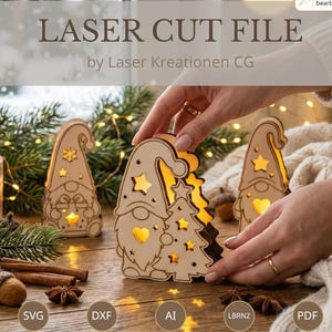May include: A laser-cut wooden gnome decoration featuring star and heart-shaped cutouts that emit a warm light. The gnome stands next to a small Christmas tree cutout. The text LASER CUT FILE by Laser Kreationen CG is visible.
