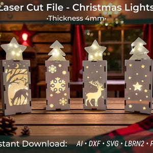 May include: Four laser-cut Christmas light decorations with star and tree toppers. Each gray wooden box features a different holiday design: a deer, snowflakes, and stars. The text reads "Laser Cut File - Christmas Lights - Thickness 4mm."