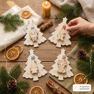 May include: Four light-colored wooden Christmas tree ornaments featuring engraved designs of a Santa, a gingerbread person, a gnome, and a reindeer. Each ornament has a slot holding a paper banknote, with the text Frohe Weihnachten engraved.