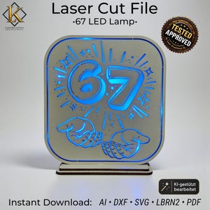 May include: A square laser-cut wooden lamp with rounded corners featuring the number 67 and two hands cupped underneath. The design is illuminated by a bright blue LED light. Text on the image includes Laser Cut File, 67 LED Lamp, and Tested Approved.