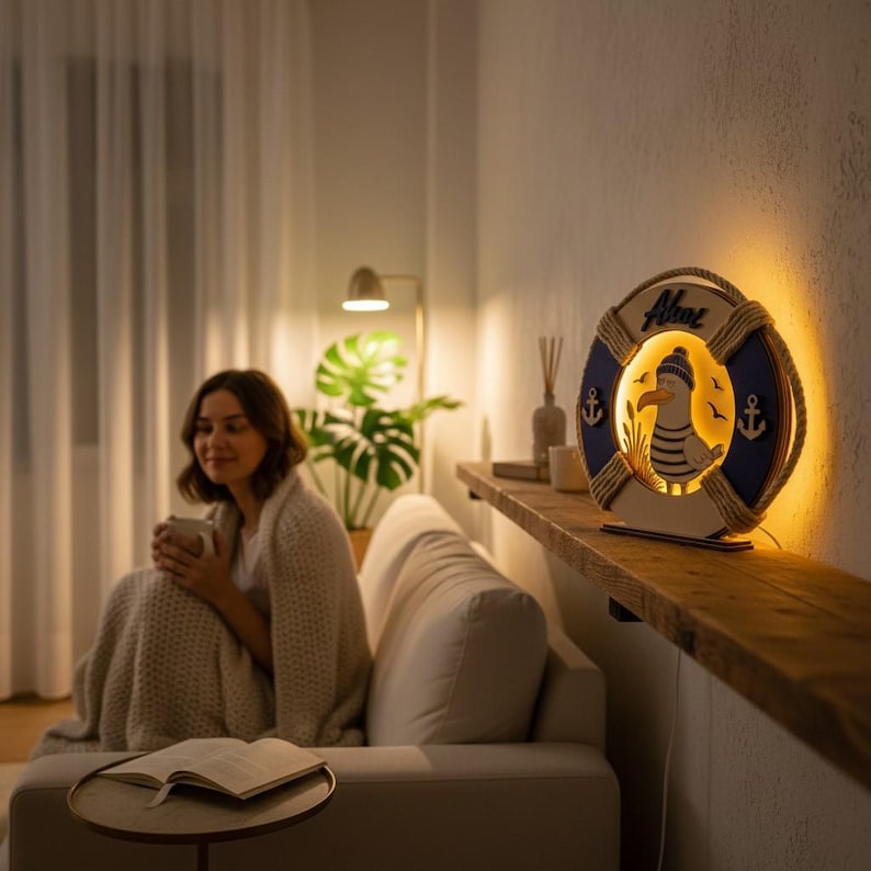 Pu&ograve; includere: Lampada decorativa a tema nautico a forma di salvagente, con un disegno di gabbiano. La lampada &egrave; blu e bianca, con dettagli in corda e motivi di ancora. La parola "Ahoy" &egrave; visibile. La lampada &egrave; illuminata, emettendo una luce calda.