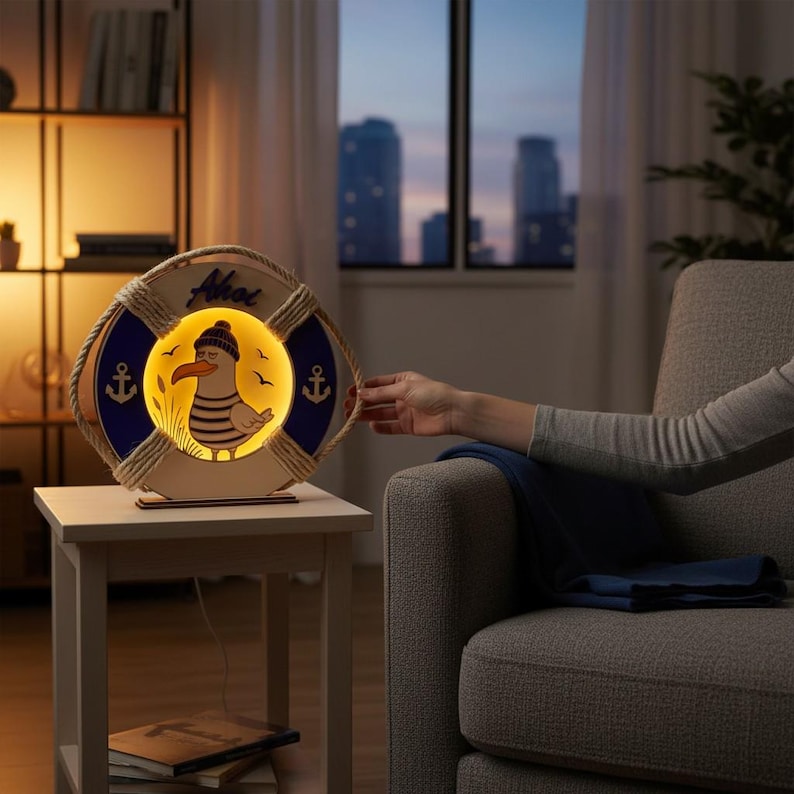 Pu&ograve; includere: Lampada decorativa a tema nautico a forma di salvagente. La lampada presenta un disegno di gabbiano dei cartoni animati all'interno di un cerchio giallo, con la scritta "Ahoi" in alto. La lampada ha dettagli blu e ancore ed &egrave; realizzata in legno.