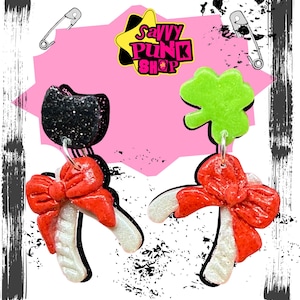 Wishbone mismatched clay earrings with a black cat/clover stud. Pop inspired.