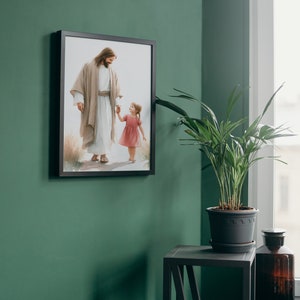 May include: A framed painting of Jesus walking with a young girl, both holding hands. The painting is on a green wall with a potted plant and a small table in the corner.