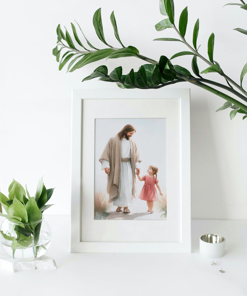 May include: A framed print of a painting depicting Jesus walking with a young girl. Jesus is wearing a light brown robe and the girl is wearing a pink dress. The painting is set against a background of green grass and a blue sky.