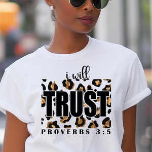 May include: White t-shirt with a leopard print design and the text "i will TRUST PROVERBS 3:5" in black.