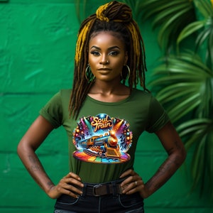 May include: Olive green t-shirt with a colorful "Soul Train" graphic featuring a train, dancers, and stage lights. The shirt has a crew neck and rolled-up sleeves. The background is a vibrant green.