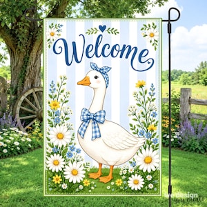 May include: A rectangular garden flag featuring a white goose wearing a blue and white gingham bow and headband. The background has light blue vertical stripes, white daisies, and yellow wildflowers. The word Welcome is printed in blue script.