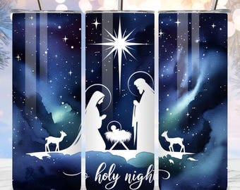 May include: A set of three stainless steel tumblers with a Christmas theme. The design features a white silhouette of the nativity scene against a dark blue watercolor background with stars. The words "holy night" are written in white script.