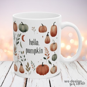 May include: White ceramic mug with an autumn-themed design. The mug features a pattern of pumpkins, leaves, and a crescent moon. The text "hello, pumpkin" is printed on the mug.